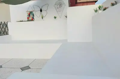 a white table with a butterfly on a wall at Cosy appartement proche de l'aéroport mohamed 5 in Deroua
