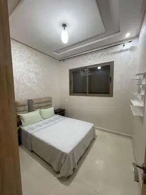 a bedroom with a bed and a window at Bahia beach . Plage dahomey in Bouznika