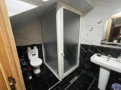a bathroom with a toilet and a glass shower at Bahia beach . Plage dahomey in Bouznika