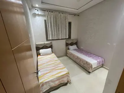 a small room with two beds and a door at Bahia beach . Plage dahomey in Bouznika
