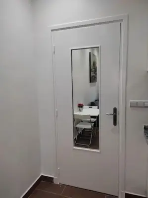 a door with a mirror and a table in a room at Joli Studio au Centre Ville avec WIFI - Netflix in Casablanca