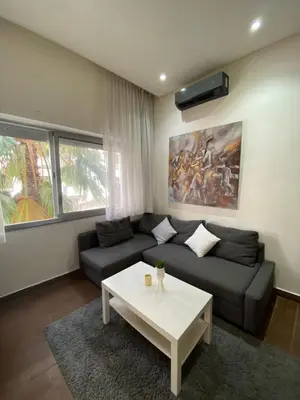 a living room with a couch and a coffee table at Joli Studio au Centre Ville avec WIFI - Netflix in Casablanca