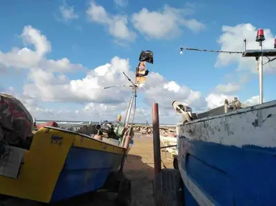 a blue and yellow boat sitting on the beach at lovely 2 bedroom vacation home with pool/beach in Skhirat