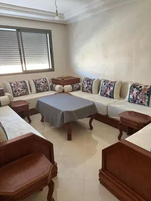 a living room with a couch and a table at Les perles de mimosa Mohammédia in Mohammedia