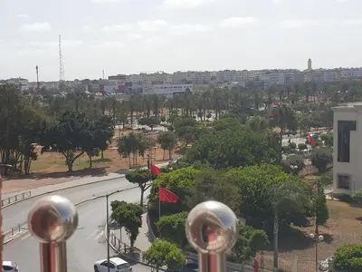 a view of a city with a road and buildings at Appartement Meublé AIN SEBAA in Aïn Sebaa