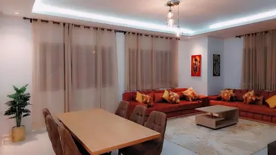 a living room with a couch and a table at Appartement Nova - Costa Bouznika in Bouznika