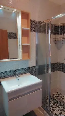 a bathroom with a sink and a shower at Appartement Nova - Costa Bouznika in Bouznika