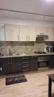 a kitchen with brown cabinets and a counter top at Casa Fainna in Casablanca
