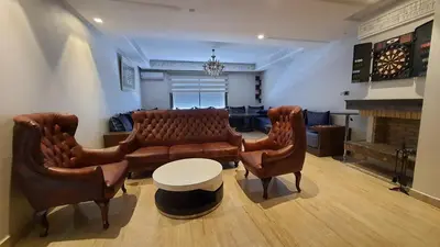 a living room with a couch and two chairs at Casa Fainna in Casablanca