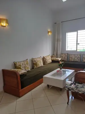 a living room with a couch and a coffee table at Super et nouvel appart proche de la plage in Temara