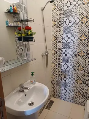 a bathroom with a sink and a shower at Super et nouvel appart proche de la plage in Temara