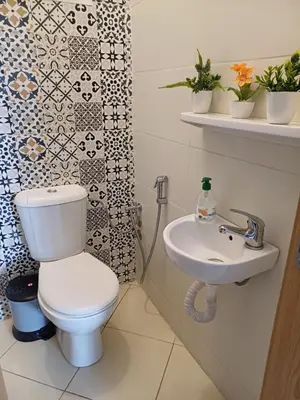 a bathroom with a toilet and a sink at Super et nouvel appart proche de la plage in Temara