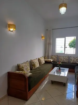 a living room with a couch and a table at Super et nouvel appart proche de la plage in Temara