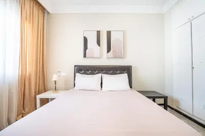 a bedroom with a large bed and a window at Grand Appartement Vue mer à Ain Diab - Calme Absolu in Casablanca