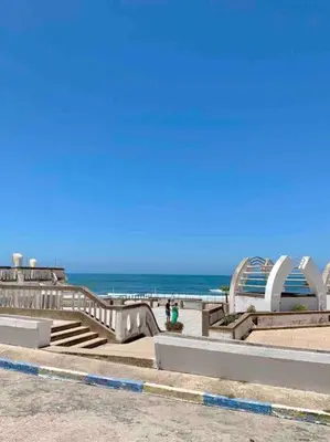 a beach with stairs and the ocean in the background at Grand Appartement Vue mer à Ain Diab - Calme Absolu in Casablanca