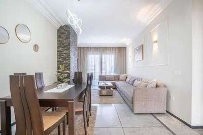 a living room with a couch and a table at Grand Appartement Vue mer à Ain Diab - Calme Absolu in Casablanca