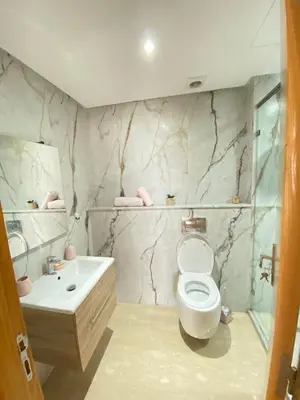 a bathroom with a toilet and a sink at Appartement en bord de mer in Pont Blondin