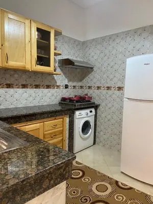 a kitchen with a white refrigerator and a washing machine at Luxurious Holiday Home in Temara