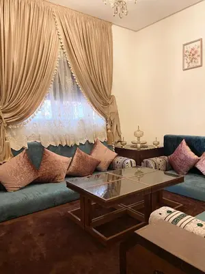 a living room with a couch and a table at Luxurious Holiday Home in Temara