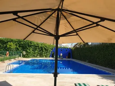 a large umbrella over a swimming pool at Hébergement bord de mer in Casablanca