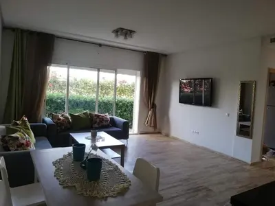 a living room with a couch and a table at Hébergement bord de mer in Casablanca