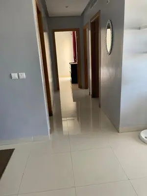 a hallway with a tile floor and a mirror at Eden tamaris résidence in Dar Bouazza