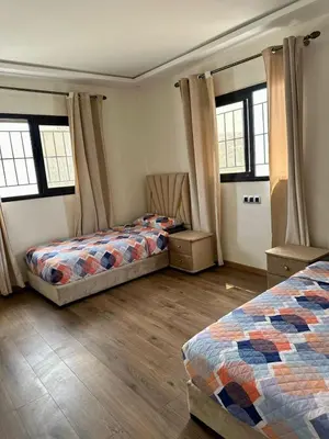 two beds in a room with two windows at sea view appart and roof top, jack beach Tamaris, Dar Bouaza in Casablanca