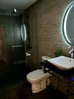 a bathroom with a toilet and a sink and a mirror at sea view appart and roof top, jack beach Tamaris, Dar Bouaza in Casablanca