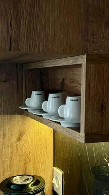 a row of white cups and saucers on a shelf at sea view appart and roof top, jack beach Tamaris, Dar Bouaza in Casablanca