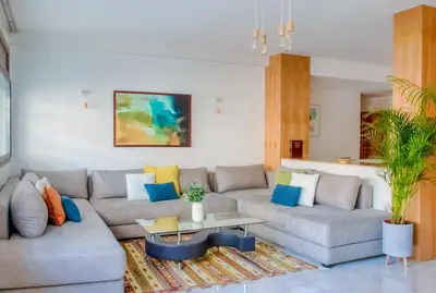a living room with two couches and a table at Luxury 3 Bedroom Apartment in the Heart of Agdal by MasterHost in Rabat