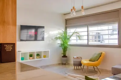 a living room with a yellow chair and a window at Luxury 3 Bedroom Apartment in the Heart of Agdal by MasterHost in Rabat