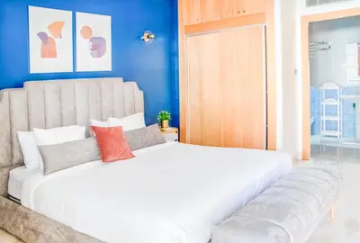 a large white bed in a room with blue walls at Luxury 3 Bedroom Apartment in the Heart of Agdal by MasterHost in Rabat