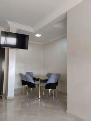 a dining room with a table and chairs at Appartement Cozy Louizia in Ben Yakhlef