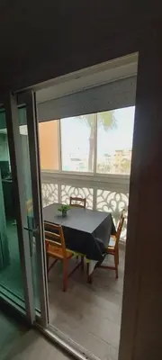 a table and chairs in a room with a window at Residence Al Kawtar in Mohammedia