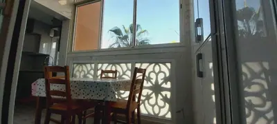 a dining room with a table and chairs and a window at Residence Al Kawtar in Mohammedia