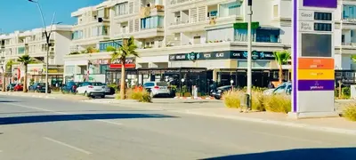 an empty street in front of a large building at Residence Al Kawtar in Mohammedia