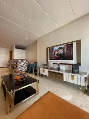 a living room with a flat screen tv on the wall at Appartement de luxe à peninsula in Casablanca