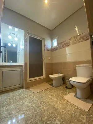 a bathroom with a toilet and a shower and a sink at Villa in Rabat in Oulad Mbark