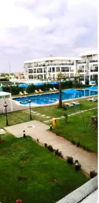a view of a large building with a swimming pool at Amwaj Beach Sidi Rahal in Casablanca
