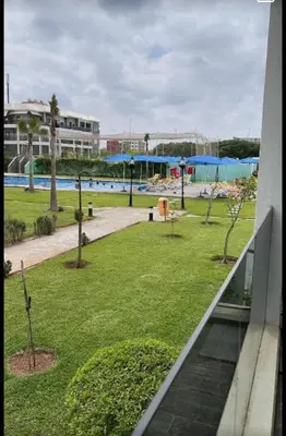 a view of a park with a swimming pool at Amwaj Beach Sidi Rahal in Casablanca