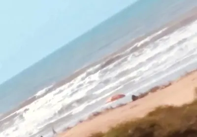 a view of a sandy beach with an umbrella at Amwaj Beach Sidi Rahal in Casablanca