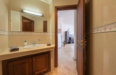 a bathroom with a sink and a mirror at Cosy Apartment 200 M2 Hay Ryad Rabat in Rabat