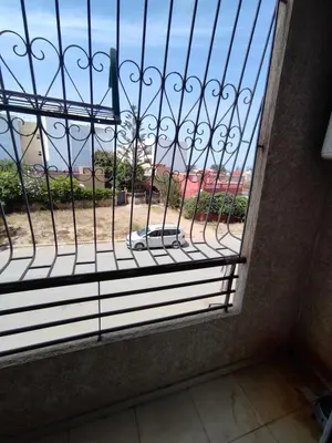 a window with a gate with a view of a beach at Molto carino ben solare in Sidi Rahal
