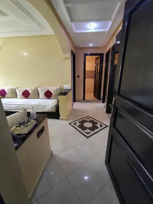 a living room with a couch and a table at Molto carino ben solare in Sidi Rahal