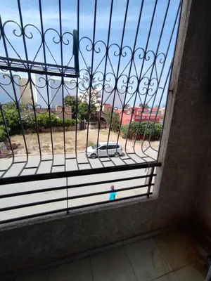a window with a gate with a view of a park at Molto carino ben solare in Sidi Rahal