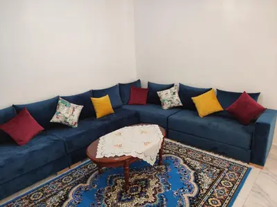 a blue couch with colorful pillows on it at Sotto ma carino in Temara