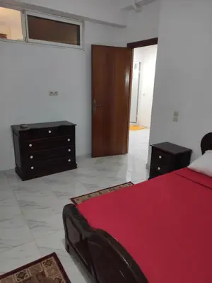 a bedroom with a red bed and a dresser at Sotto ma carino in Temara