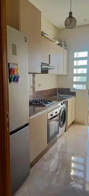 a kitchen with a refrigerator and a stove top oven at Residence Casa Bay Sidi Rahal in Sidi Rahal