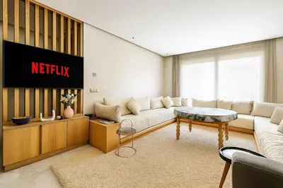 a living room with a couch and a tv at Lux, comfy and cosy Apartment in Casablanca