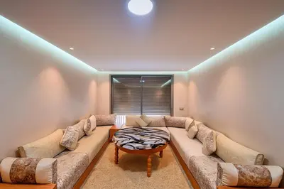 a living room with a large couch and a table at Lux, comfy and cosy Apartment in Casablanca